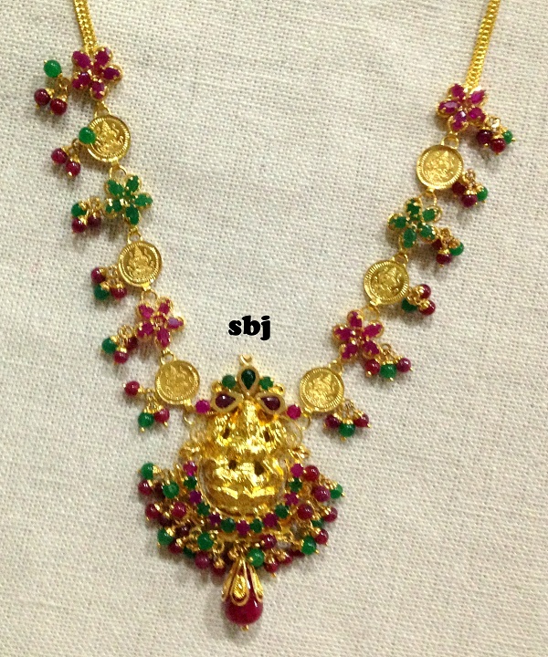 gold set with rubies and emeralds